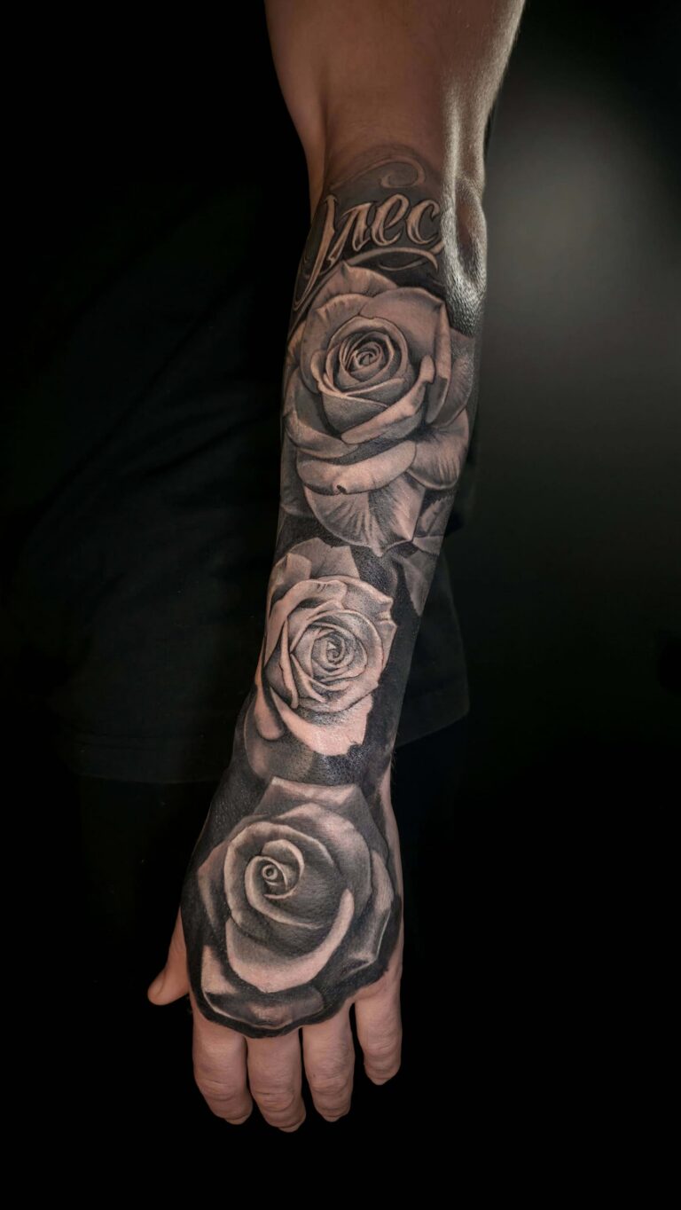 Black and grey rose cover up tattoo on arm – realistic floral design hiding old tattoo, cover up tattoo in Tallinn